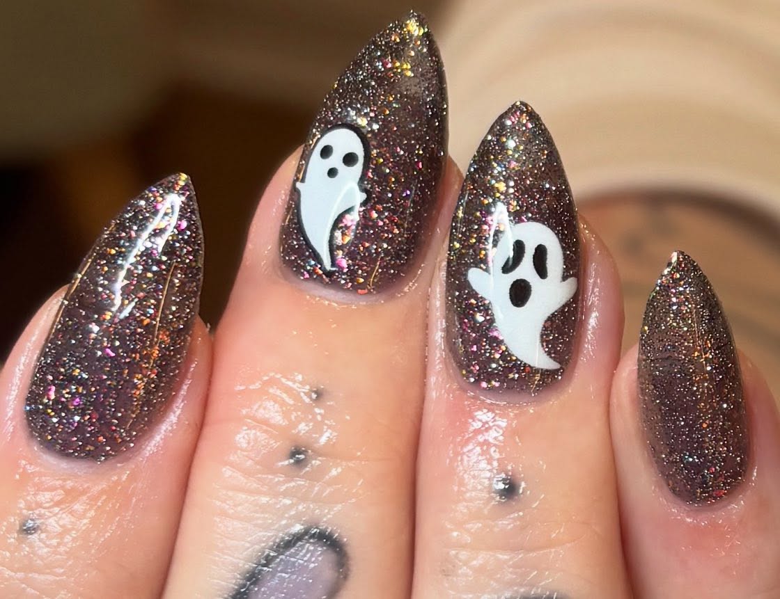 Get your spook on with these enchanting Halloween nails! 🎃This glittery, ghostly design combines a shimmering base with ghost nail art for a look that’s both fun and festive. 👻 Book your Halloween n