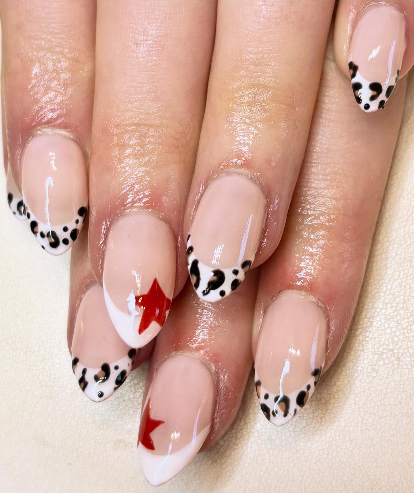 Hand-painted French tips featuring delicate animal print and bold red star accents for that perfect mix of cute & edgy ⭐️

Gel X extensions giving strength & a flawless finish 💅
Every detail painted 
