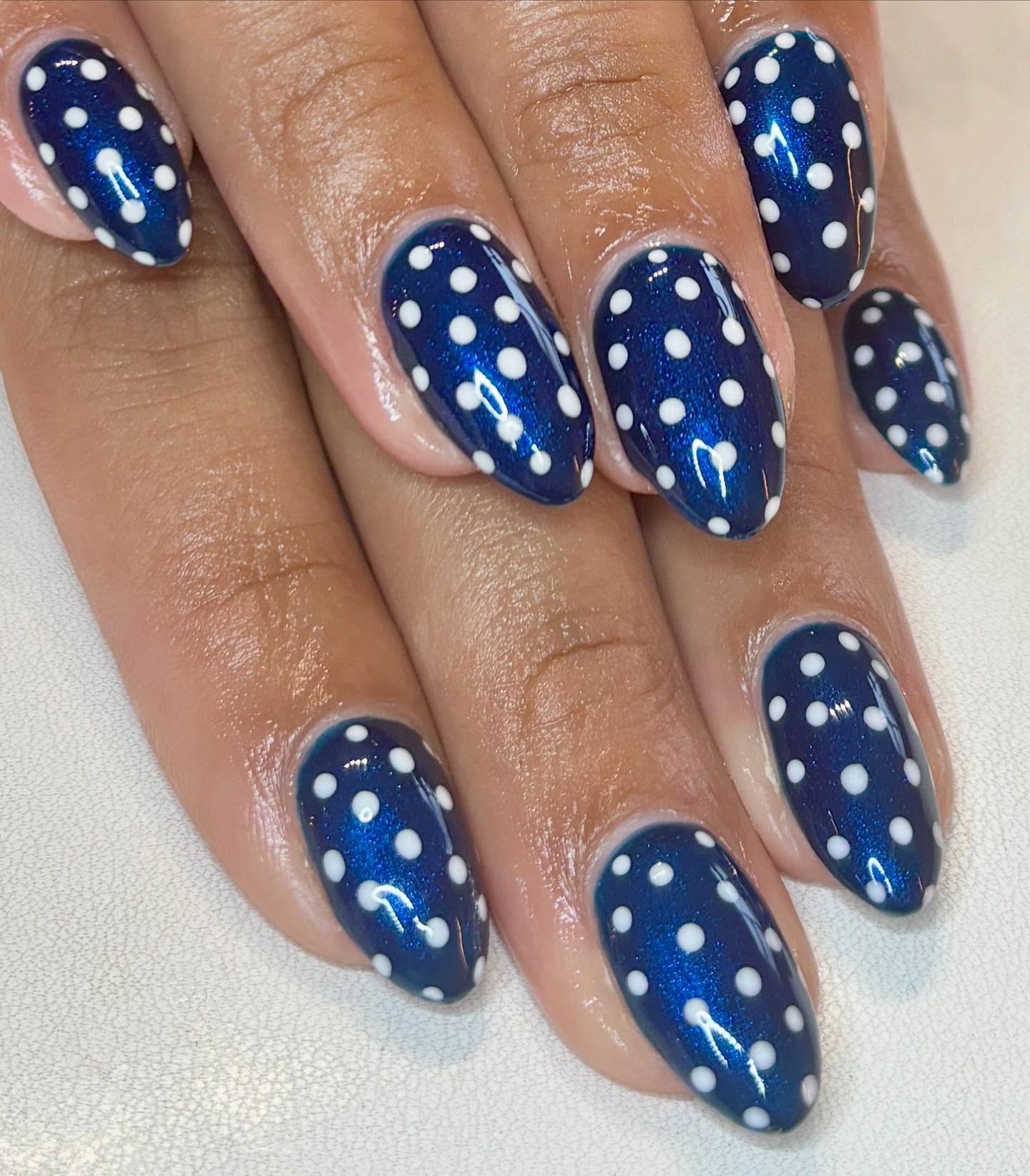 Check out this builder gel set on natural nails! The pearl navy blue base compliments the white polka dots perfectly 💙✨ Book your appointment today to have stunning nails like these! #nailsbyabby #po